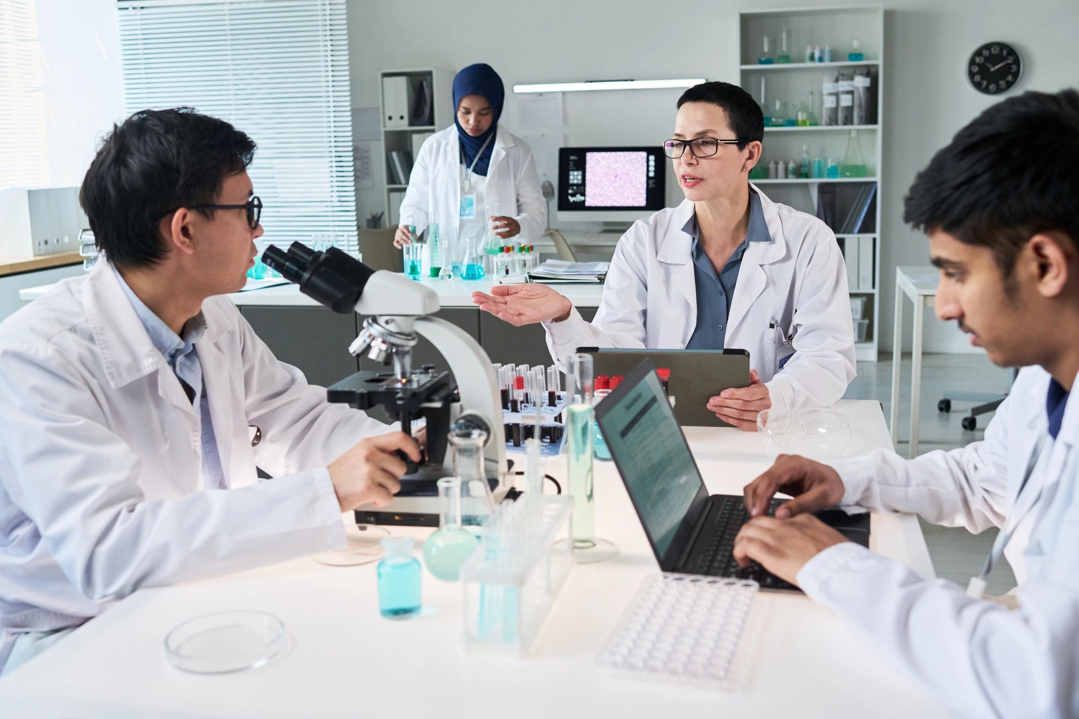 Diverse Scientists Collaborating in Laboratory Research Meeting